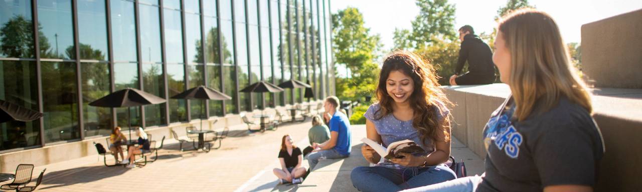 GVSU students studying in front of the library.